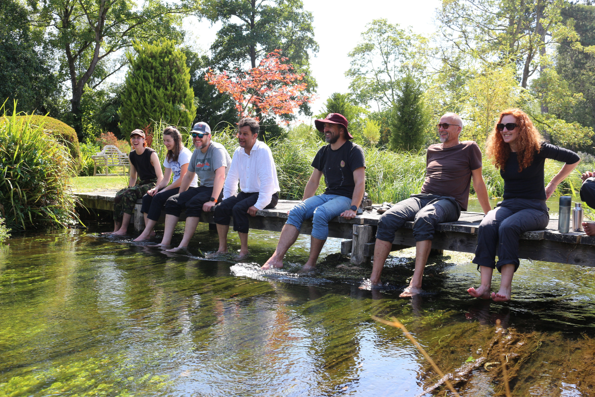 Social sharing card for Hampshire architects swap desks for waders to help clear invasive plants from the River Test